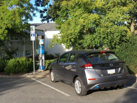 Electric Car being charged in outdoor parking lot